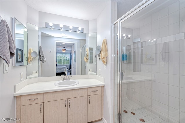 bathroom with a stall shower, a ceiling fan, connected bathroom, and vanity