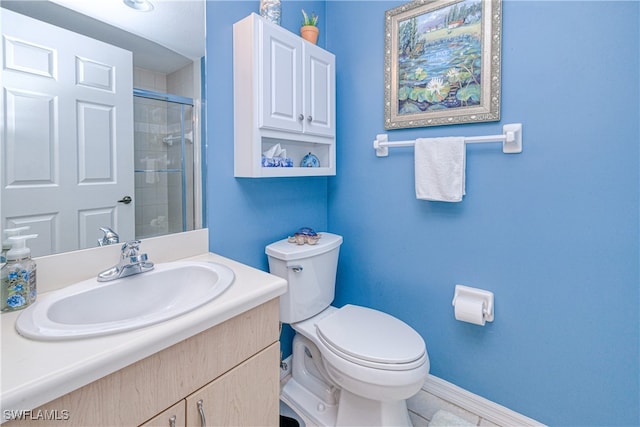 bathroom featuring a tile shower, vanity, toilet, and baseboards