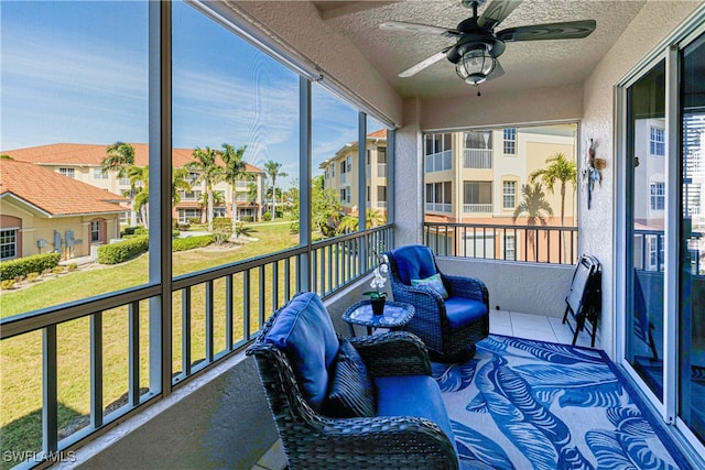 balcony with a ceiling fan and a residential view