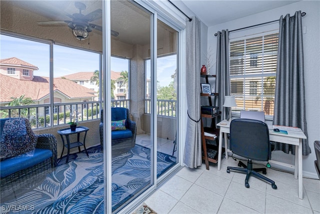 tiled office space with a sunroom and ceiling fan