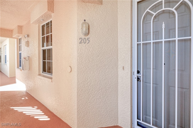 doorway to property with stucco siding