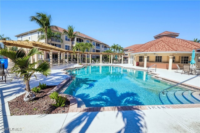 pool with a pergola and a patio