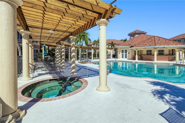 community pool featuring french doors, a patio area, and a hot tub