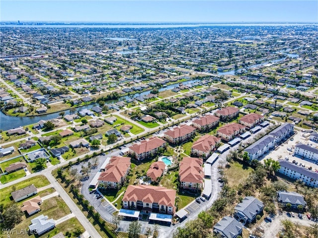 birds eye view of property featuring a water view and a residential view