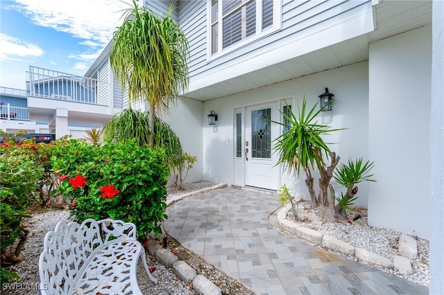 entrance to property featuring stucco siding