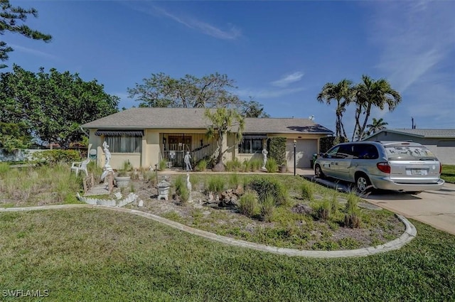 single story home with a garage, stucco siding, concrete driveway, and a front yard