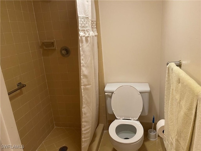 bathroom with a shower stall and toilet