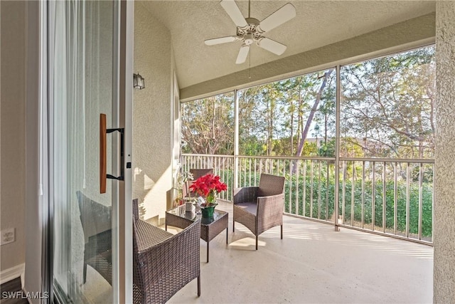 sunroom featuring a ceiling fan