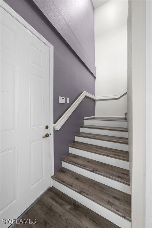 staircase featuring wood finished floors