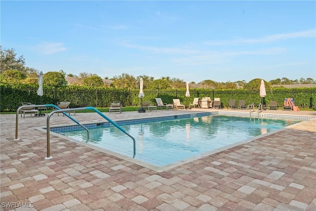 pool with fence and a patio