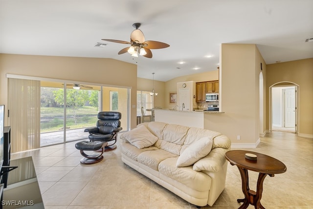 living room with light tile patterned floors, visible vents, arched walkways, a ceiling fan, and vaulted ceiling