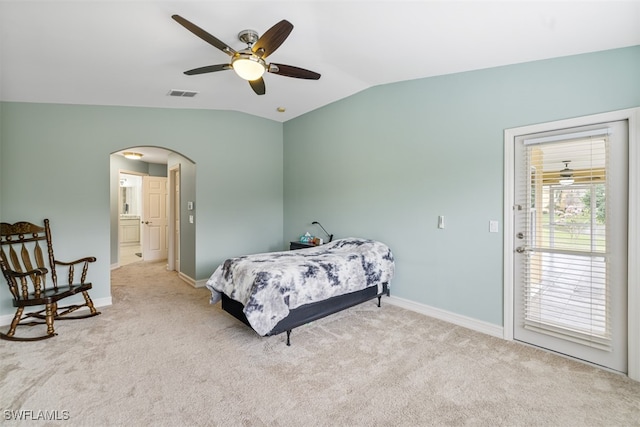 carpeted bedroom with arched walkways, a ceiling fan, visible vents, vaulted ceiling, and baseboards