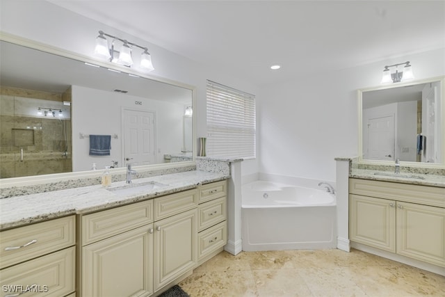 full bath featuring two vanities, a sink, a bath, and a shower stall