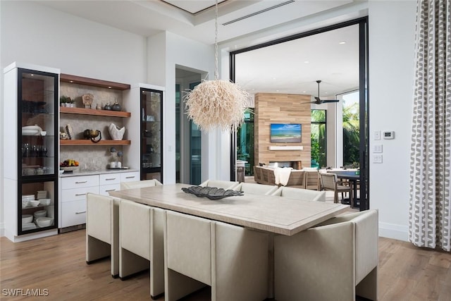 dining area with baseboards and light wood finished floors