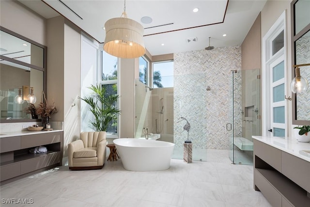 full bath featuring recessed lighting, vanity, a shower stall, and a freestanding bath