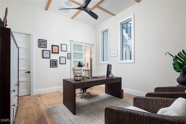 office space with a ceiling fan, light wood-style floors, and baseboards