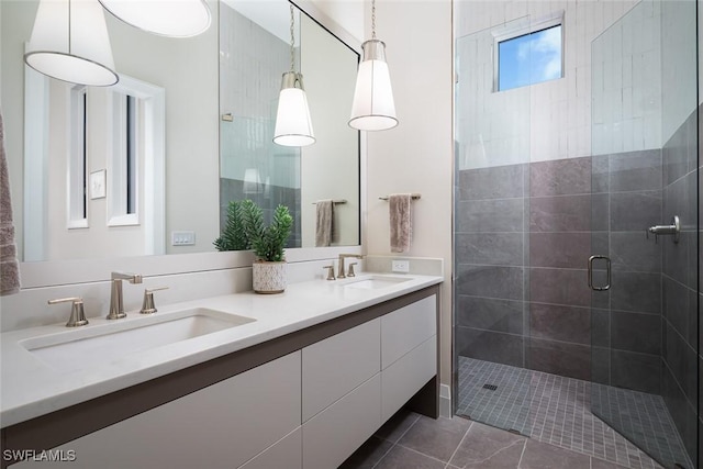 full bathroom with tile patterned flooring, a shower stall, double vanity, and a sink