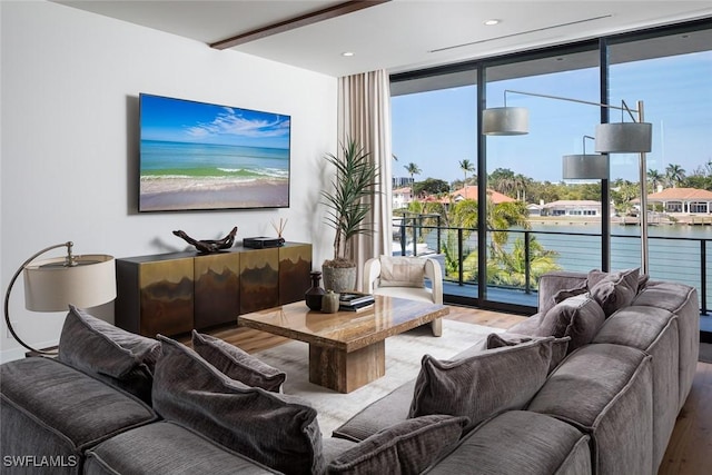 living area featuring recessed lighting, floor to ceiling windows, and wood finished floors