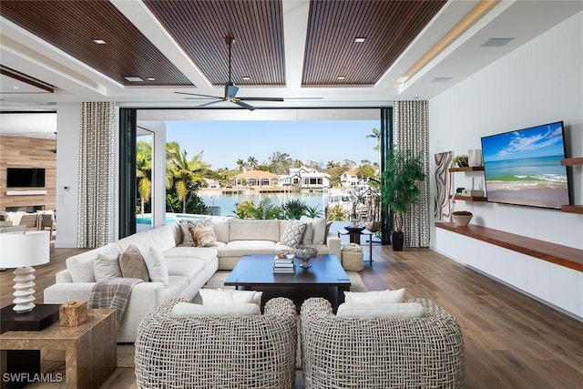 interior space featuring a tray ceiling, floor to ceiling windows, wood finished floors, and ceiling fan