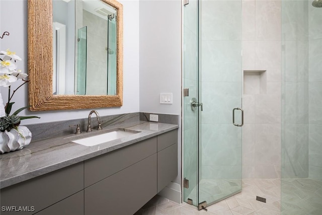 full bath with vanity and a shower stall