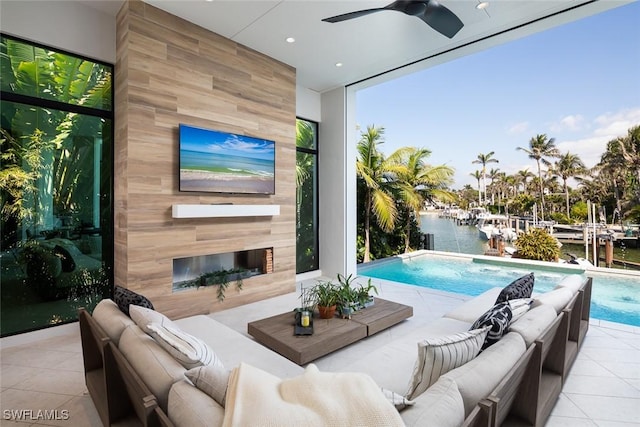 tiled living area featuring a wall of windows, a premium fireplace, ceiling fan, and recessed lighting