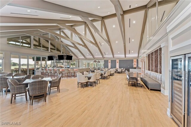 22810 Sago Pointe Dr Unit 2403, Estero, FL 34135 - dining space featuring high vaulted ceiling, wood finished floors, beam ceiling, and beverage cooler