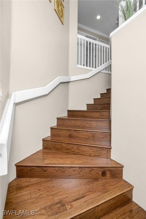 22810 Sago Pointe Dr Unit 2403, Estero, FL 34135 - stairs featuring crown molding, recessed lighting, and wood finished floors