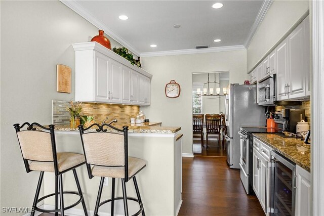 22810 Sago Pointe Dr Unit 2403, Estero, FL 34135 - kitchen with wine cooler, stainless steel appliances, a peninsula, white cabinets, and stone countertops