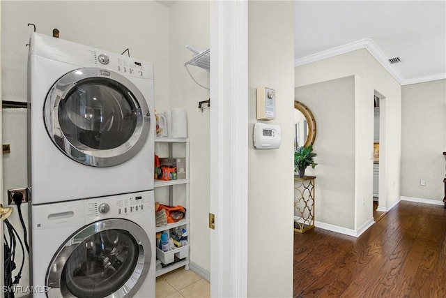 22810 Sago Pointe Dr Unit 2403, Estero, FL 34135 - washroom with estacked washer and dryer, ornamental molding, baseboards, and wood finished floors