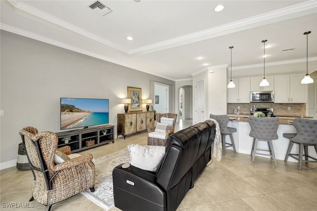 living room featuring arched walkways, light tile patterned floors, recessed lighting, visible vents, and crown molding