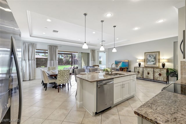 kitchen featuring white cabinets, appliances with stainless steel finishes, a raised ceiling, and hanging light fixtures