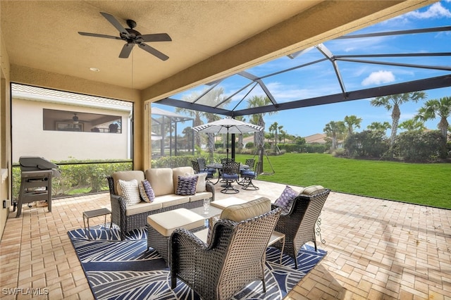 view of patio / terrace featuring area for grilling, outdoor lounge area, a lanai, and a ceiling fan