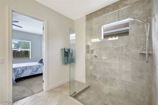 full bath featuring ensuite bathroom, tile patterned flooring, a tile shower, and baseboards