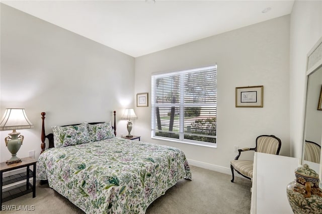 bedroom featuring light colored carpet and baseboards