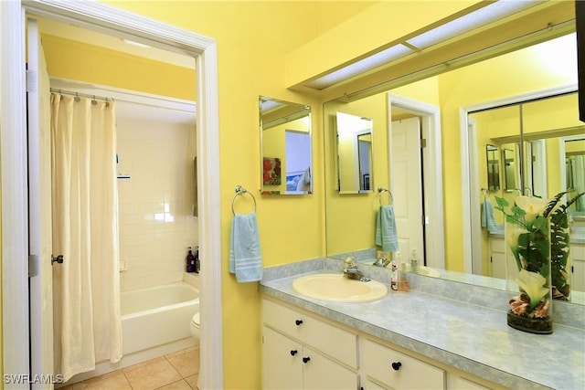 full bathroom featuring shower / bath combination with curtain, vanity, tile patterned flooring, and toilet