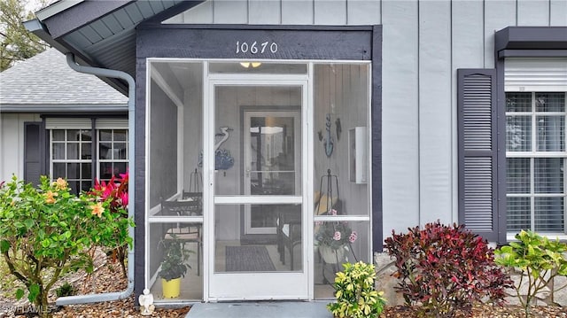 property entrance featuring board and batten siding