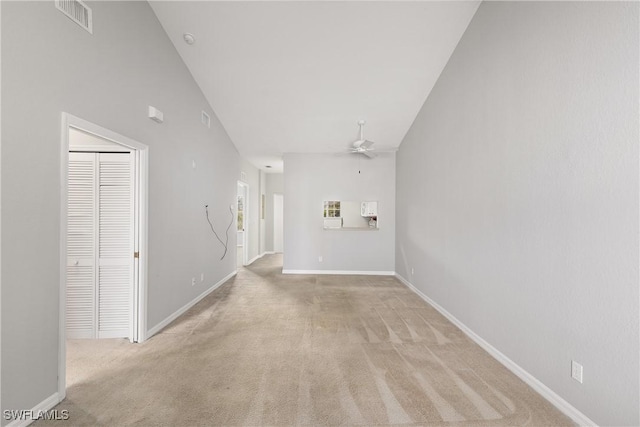 unfurnished living room with baseboards, visible vents, a ceiling fan, and light colored carpet