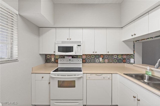 kitchen with light countertops, white appliances, and white cabinetry