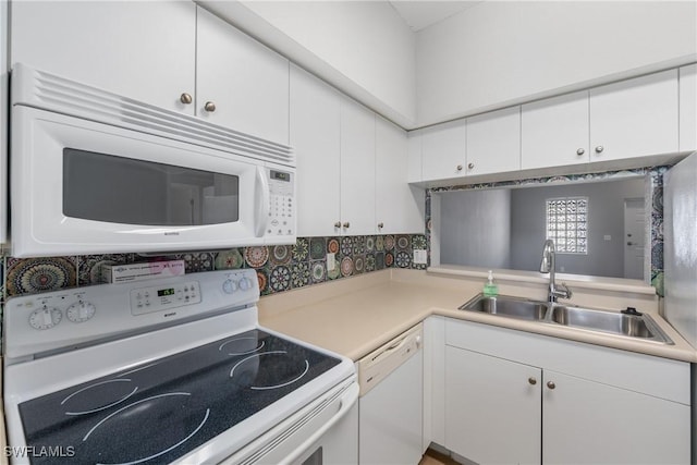 kitchen featuring light countertops, white appliances, a sink, and white cabinets