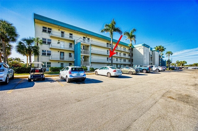 view of property featuring uncovered parking