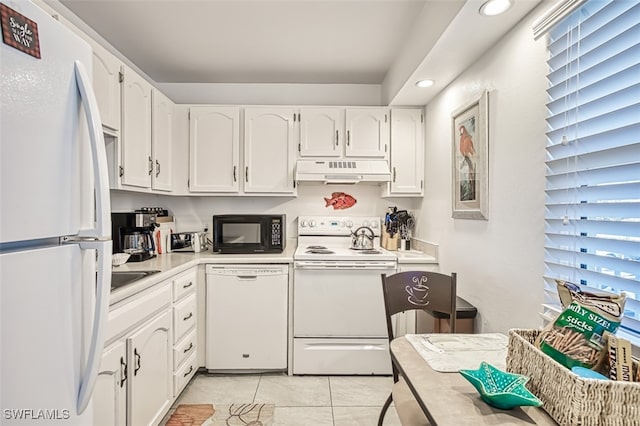 kitchen featuring light countertops, white appliances, white cabinetry, and under cabinet range hood