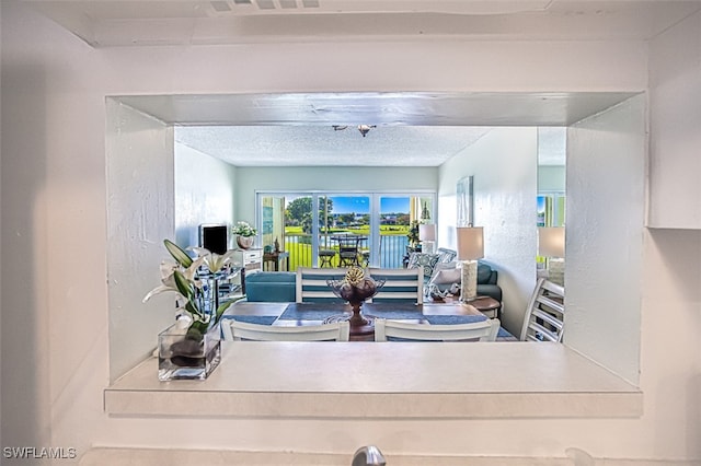 living area featuring a textured ceiling