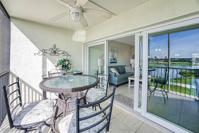 exterior space with a water view and ceiling fan