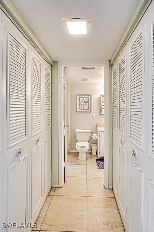 corridor featuring visible vents and baseboards