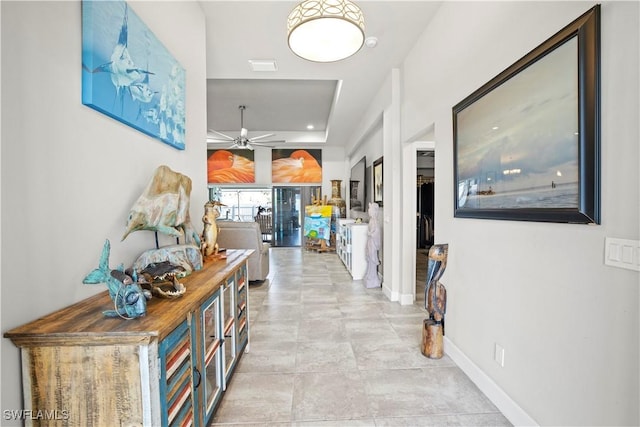 corridor featuring baseboards and visible vents