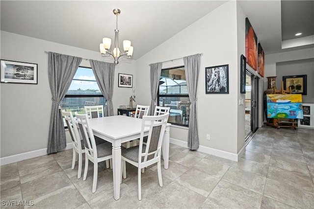 dining room with an inviting chandelier, plenty of natural light, baseboards, and vaulted ceiling