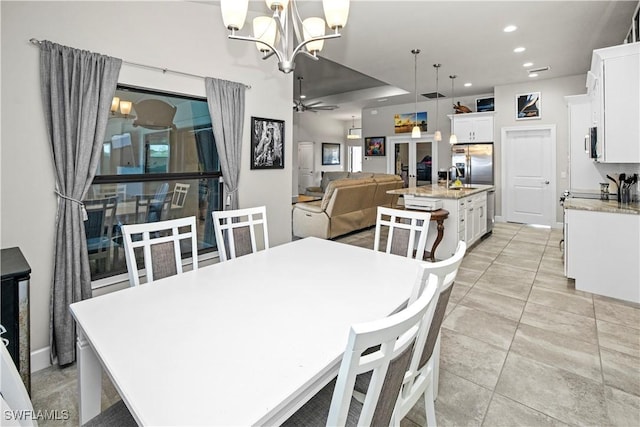 dining area featuring light tile patterned floors, recessed lighting, and ceiling fan with notable chandelier