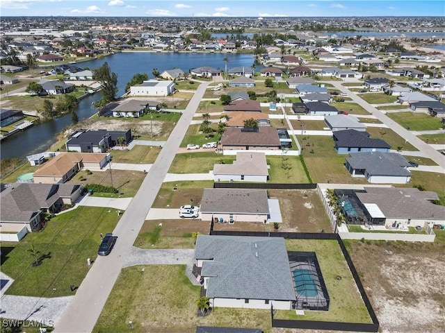 drone / aerial view featuring a residential view and a water view