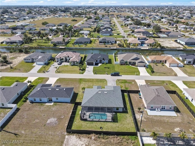 drone / aerial view with a water view and a residential view