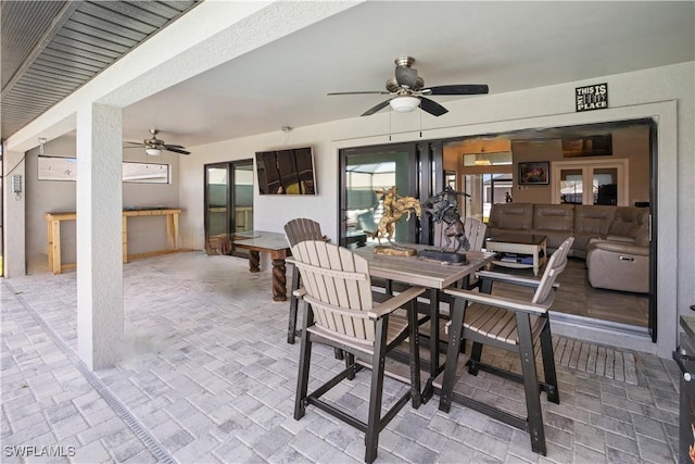 dining space featuring brick floor and a ceiling fan